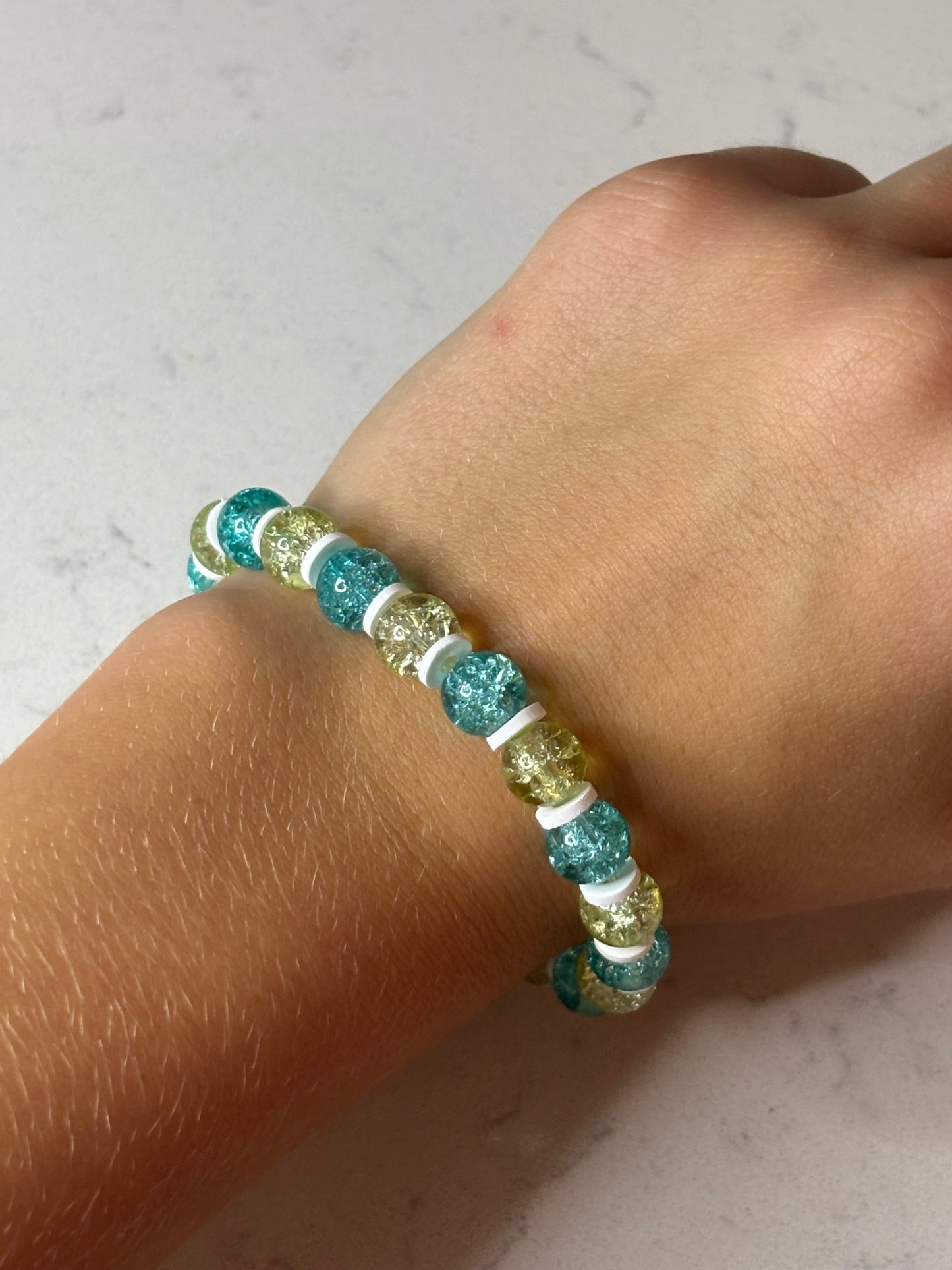 Blue and yellow and white glass and clay beaded bracelet